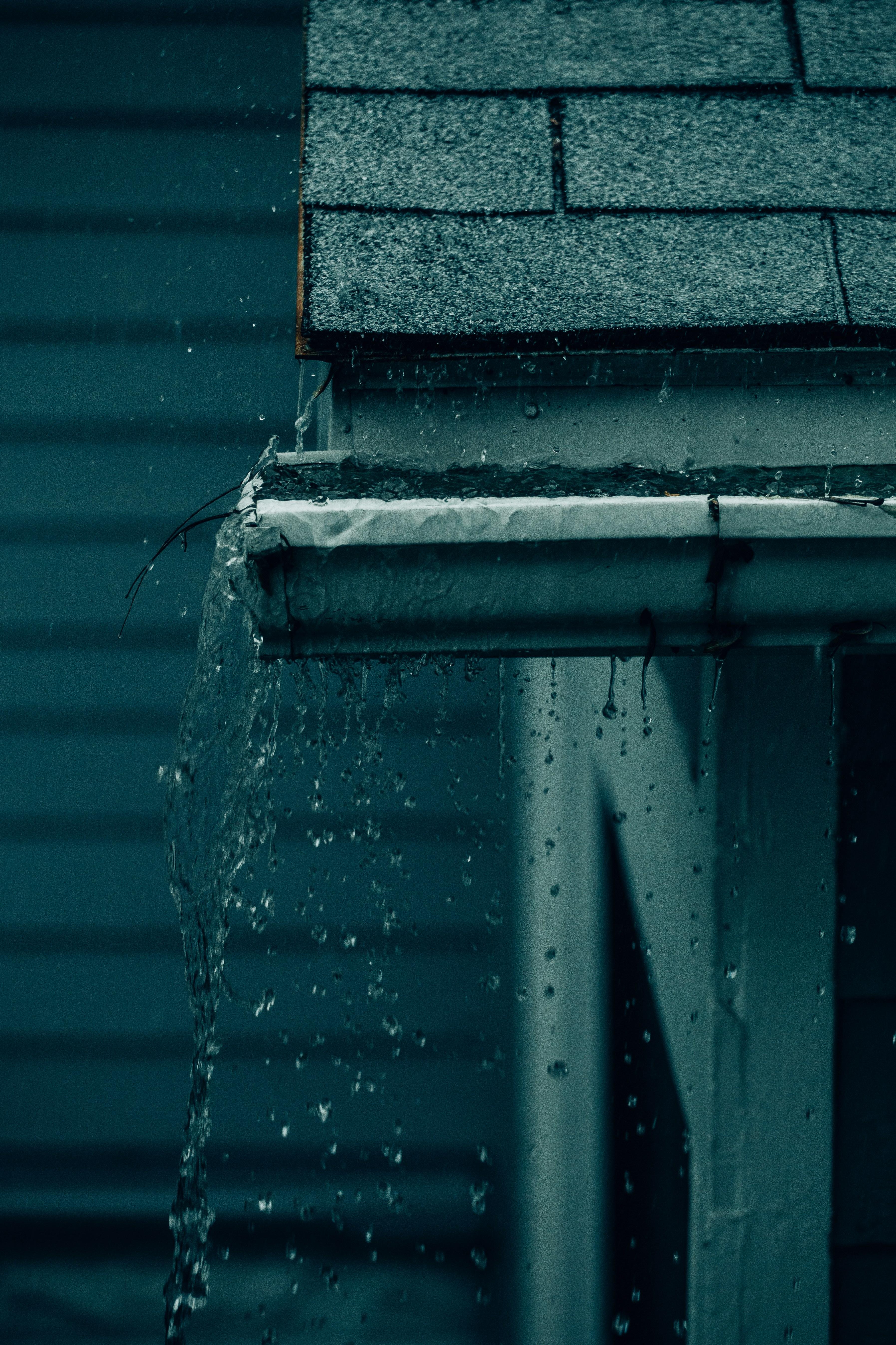 Gutter overflowing with rainwater — the damage gutters prevent