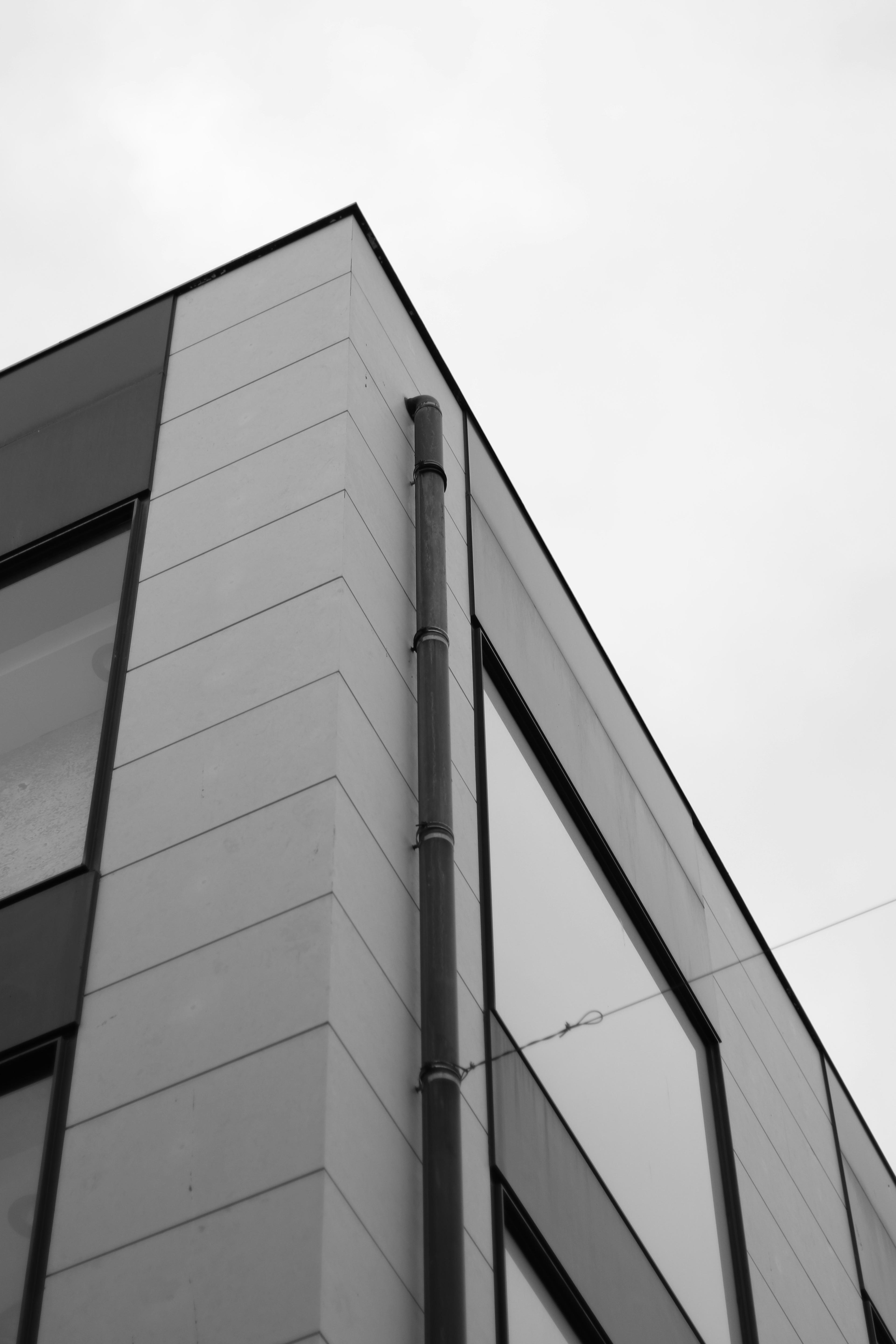 Modern commercial building corner with downspout drainage system